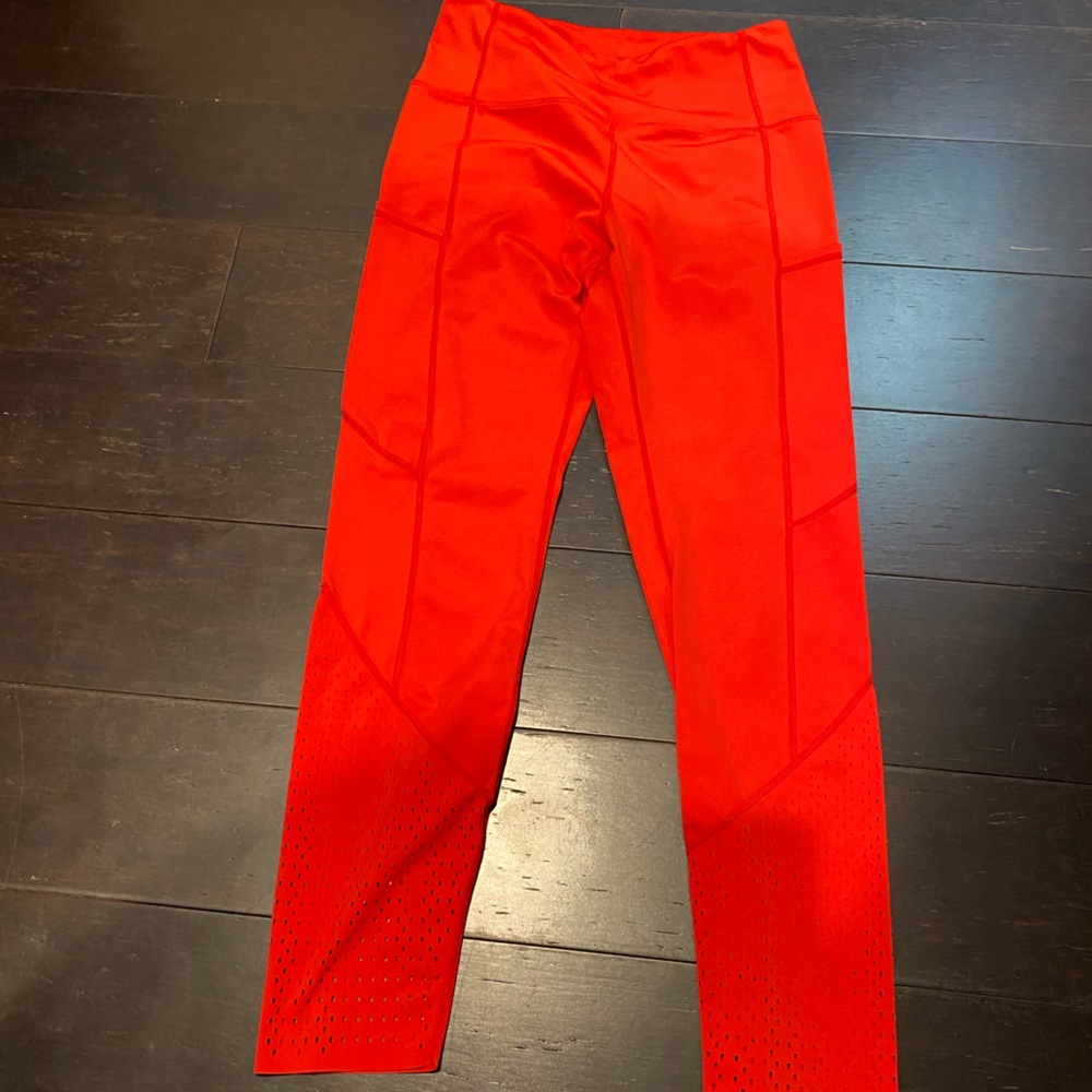 Red Zyia leggings with vented bottom detail
